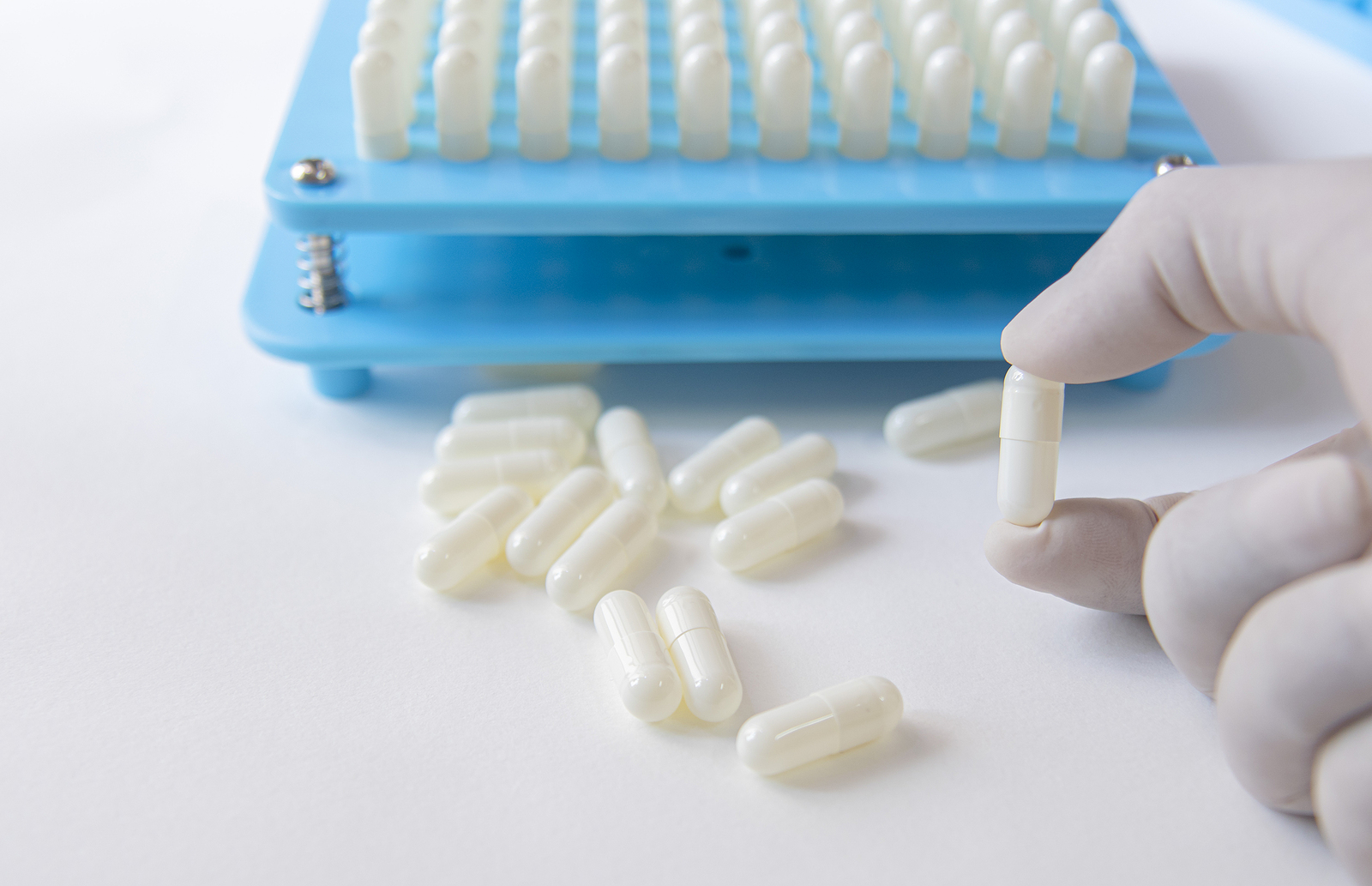 White pill capsules in production
