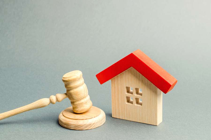 Miniature wood of a gavel and a home. Conveyancing concept