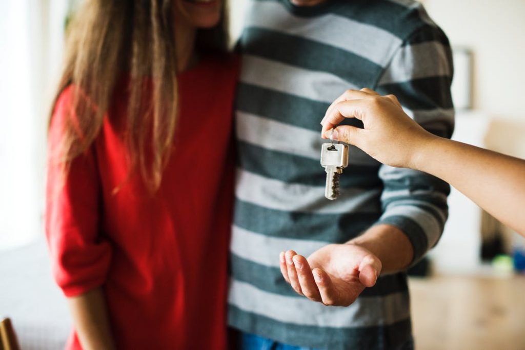 Couple receiving the key to a home from a conveyancer in Campbelltown